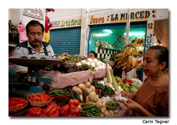 Pilar Cabrera buys fresh ingredients for the class at the local market. 